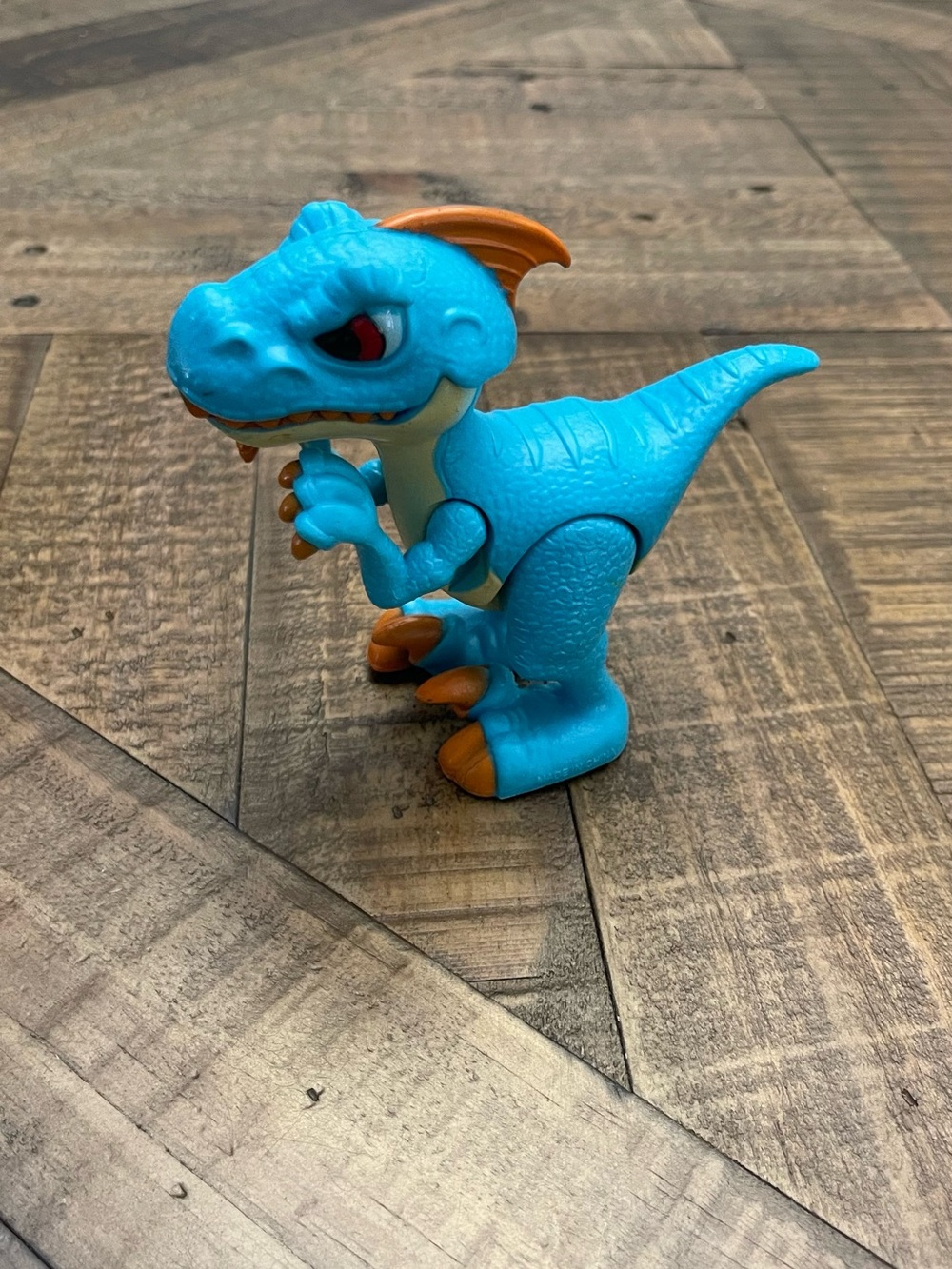 a Happyline Dino Troops Kids articulated Raptor toy